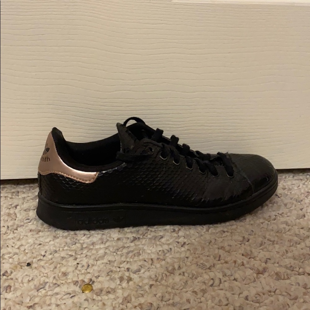Black leather adidas shoes.